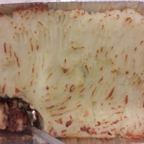 A pan of Shepherd's Pie with a piece missing