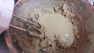 Tahini paste sitting on top of the creamed margarine, brown sugar, egg mixture