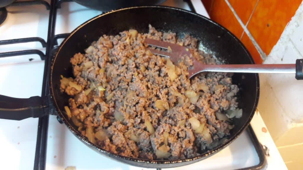 large frying pan containing cooked chopped meat and onions ~ bitesnpieces.co