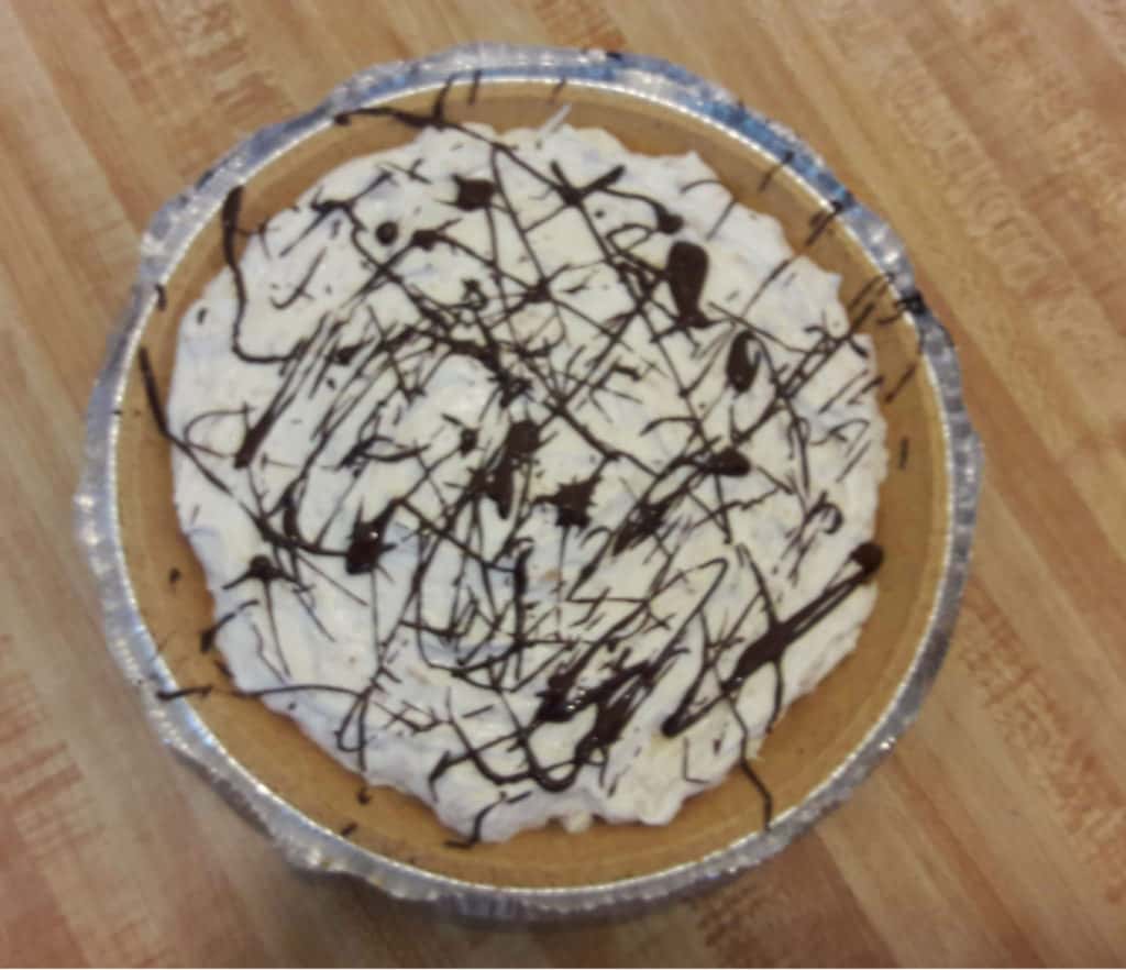 No bake peanut butter pie drizzled with melted chocolate, sitting on a table ~ bitesnpieces.co