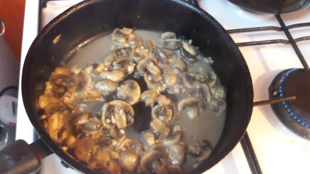 Sauteed mushrooms in saucepan on the stove 